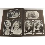 An album of approx 75 photographic postcards of film stars including Bette Davis, Greta Garbo and