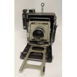 A Graflex Speed Graphic folding camera with 135mm 4.7 lens, Rapax shutter, serial number 839736 in