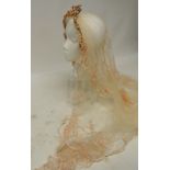 A c.1910 - 1920 wedding veil with integral wire and wax floral head-dress, the fine flounced net