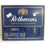 A plastic Rothmans shop door display sign for opening times and with small clock 26.5cms x 32cms