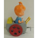 A vintage plastic clockwork musical Pebbles in a pram 27cms high ++movement winds but reluctant to