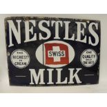 A single sided enamel metal advertising sign "Nestles Milk", white lettering on blue ground, 38.5cms