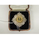 A Scots Guards sterling silver badge with green enamel and gilt metal centre, now fitted with brooch