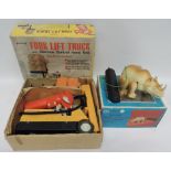 A Japanese made battery operated Rhinoceros, in original box together with a Palitoy battery