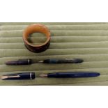 A Parker Slimfold fountain pen in dark blue case; a Conway Stewart "Dinkie" 560 fountain pen in