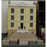 A large modern Georgian style dolls town house on base board and with road frontage, steps to the