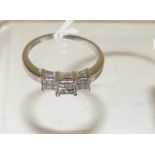 An 18ct white gold large size ring, set with three panels of four square cut diamonds, size W.