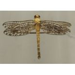 A 9ct gold brooch in the form of a dragonfly with pierced filigree type wings, the eyes inset with