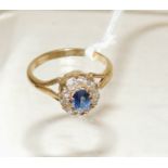 An 18ct gold dress ring set with a central blue sapphire with a surround of ten diamonds, openwork