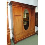 An early 20th century inlaid mahogany double wardrobe with moulded cornice, central oval bevelled