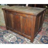 An early 20th century oak coffer bach, having simple carved decoration, panelled lid and sides, 44cm