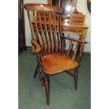 A late 19th/early 20th century farmhouse slat back Windsor chair, with out-curving arms, elm seat