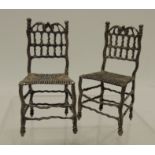 A pair of 18th Century Dutch hand made miniature silver chairs having open work spindle and rail