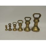 A matched set of six brass bell weights 7lbs to 4oz two marked for Avery Ltd (6)