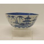 A small 19th Century Japanese porcelain bowl painted in underglaze blue with pagodas, willow tree,