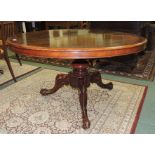 A Victorian circular tilt top breakfast table on turned pillar and four moulded scrolling