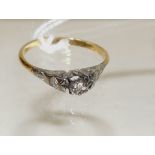 An 18ct gold illusion set solitaire diamond ring, openwork setting, size N.