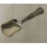 A Victorian silver caddy spoon with shell and scroll decoration to the handle and engraved rampant