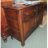 An Ercol dark elm sideboard, fitted with two drawers above cupboards, with panelled sides, 84cm