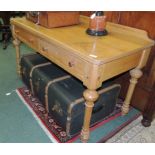 A pine washstand with low raised back, two frieze drawers and on turned supports, 119cm wide.