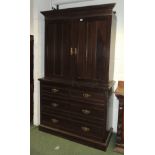A late 19th century dark stained pine compactum, the upper section with doors enclosing hanging area