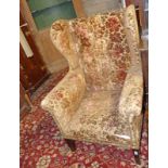 LATE 19TH CENTURY WINGBACK ARMCHAIR ON MAHOGANY SQUARE SUPPORTS