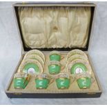 CASED SPODE "RUSKIN" COFFEE SET WITH GREEN & GILT DECORATION & WITH FLORAL DECORATION TO THE CUP