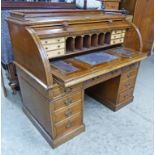 LATE 19TH CENTURY OAK TWIN PEDESTAL CYLINDER BUREAU WITH GALLERY TOP OVER ROLL TOP WITH FITTED