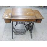 OAK CASED SINGER TREADLE SEWING MACHINE Condition Report: machine is present.