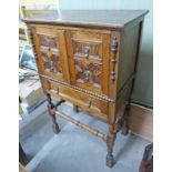 EARLY 20TH CENTURY OAK CABINET ON STAND WITH 2 PANEL DOORS OVER DRAWER ON TURNED SUPPORTS