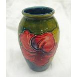 MOORCROFT POTTERY BALUSTER VASE DECORATED WITH ORCHIDS ON A GREEN AND BLUE GROUND ,
