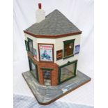 DOLLS HOUSE IN THE STYLE OF A CORNER SHOP WITH ADVERTISING SIGNS INCLUDING GUINNESS, PERSIL,