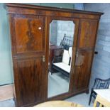 EARLY 20TH CENTURY MAHOGANY TRIPLE MIRROR DOOR WARDROBE WITH FITTED INTERIOR ON BRACKET SUPPORTS