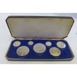 1887 CASED SET OF 7 COINS,