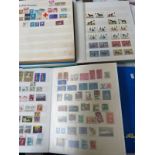 FOUR ALBUMS OF WORLDWIDE STAMPS