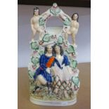 19TH CENTURY STAFFORDSHIRE POTTERY WATCH HOLDER FIGURE GROUP - 32 CM TALL