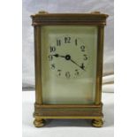 GILT BRASS CARRIAGE WITH CREAM ENAMEL DIAL AND FRETWORK DECORATION - 13 CM TALL