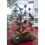 GLASS DOME CONTAINING 18 TAXIDERMY EXOTIC BIRDS ON A BRANCH Condition Report: