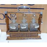 OAK TANTALUS WITH SILVER PLATED MOUNTS & 3 DECANTERS WITH SILVER WHISKY,