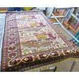 MIDDLE EASTERN RED AND CREAM CARPET DECORATED WITH FIGURES 107 X 162 CMS