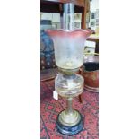 OIL LAMP WITH BRASS COLUMN AND CRANBERRY GLASS SHADE