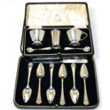 A silver cruet set, retailed by Harrods (cased) and a set of six silver fruit spoons with a knife (