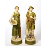 A pair of Royal Dux figures in the neo-classical style, hunter and fisher woman, integral plinth