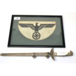 A copy of a German Third Reich Diplomat's dagger; a German Third Reich Army sports vest emblem,