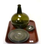 Large green glass onion bottle and a quantity of pewter plates