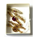 Two garnet set bar brooches and three other bar brooches (5)