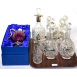 Three pairs of cut glass decanters with silver wine labels, a silver collared decanter, two silver