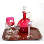 A Victorian cranberry glass claret jug; similar stem goblet; 18th century opaque twist wine glass