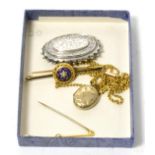 A Victorian seed pearl and enamel brooch, a peridot brooch, a locket on chain and a Victorian silver