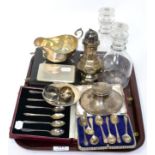 A group of silver including a sauce boat, a cigarette box, a dish, two napkin rings, a capstan